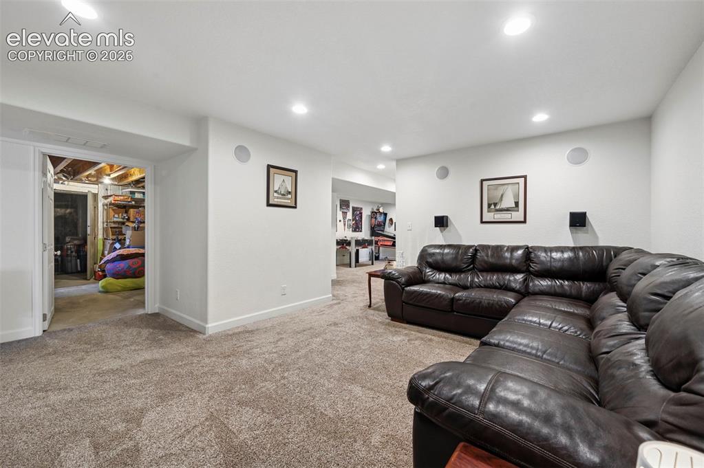Image 37 of 50: Large Family Room in Basement looking to storage room