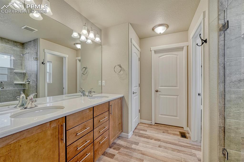 Image 11 of 50: Primary bathroom features quartz counter