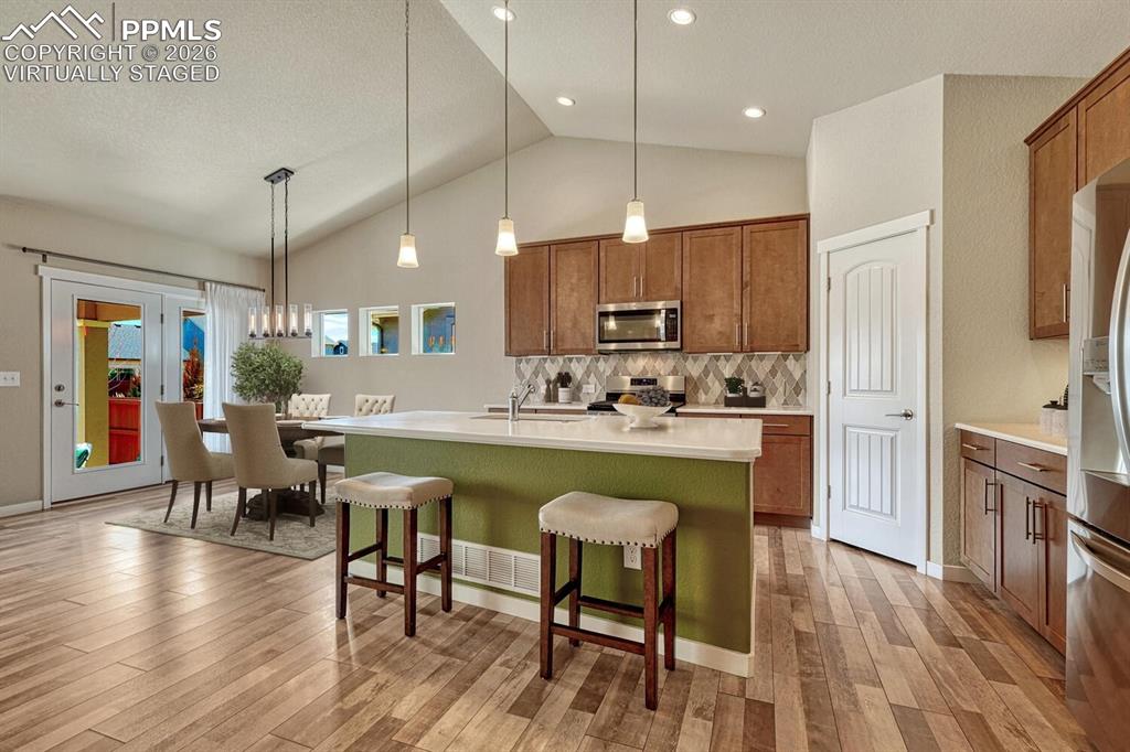 Image 6 of 50: Kitchen and dining virtually staged