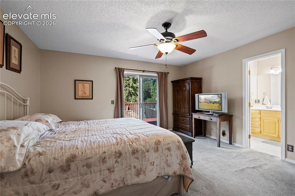 Image 15 of 43: Plush carpeting, ceiling fan with integrated lighting, and direct access to