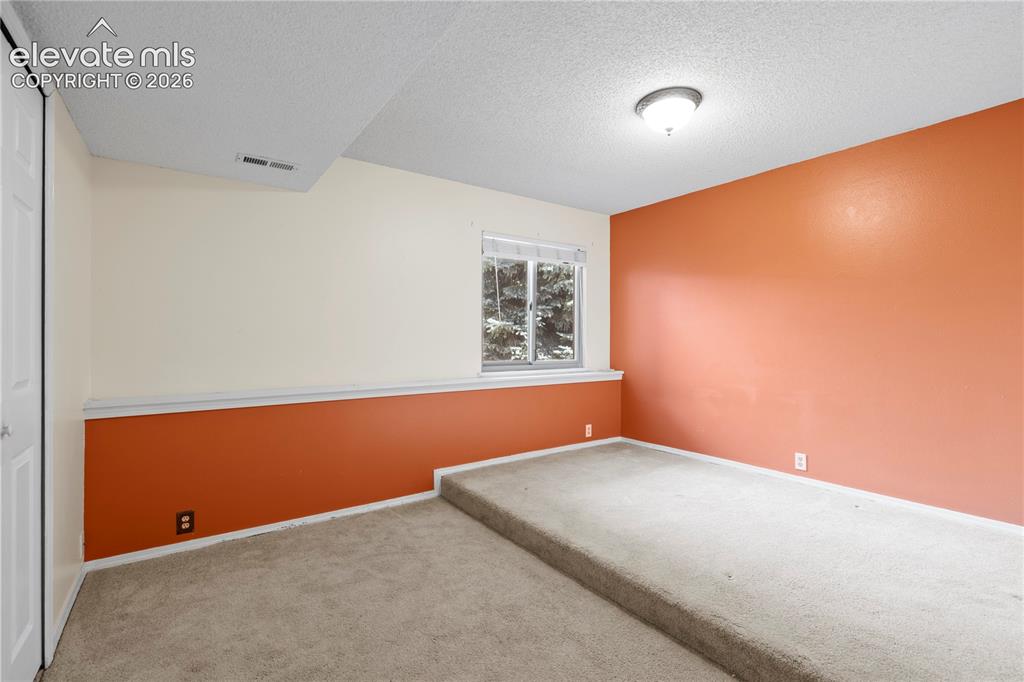 Image 31 of 43: Recessed window, two-tone wall treatment, built-in elevated platform, wall-