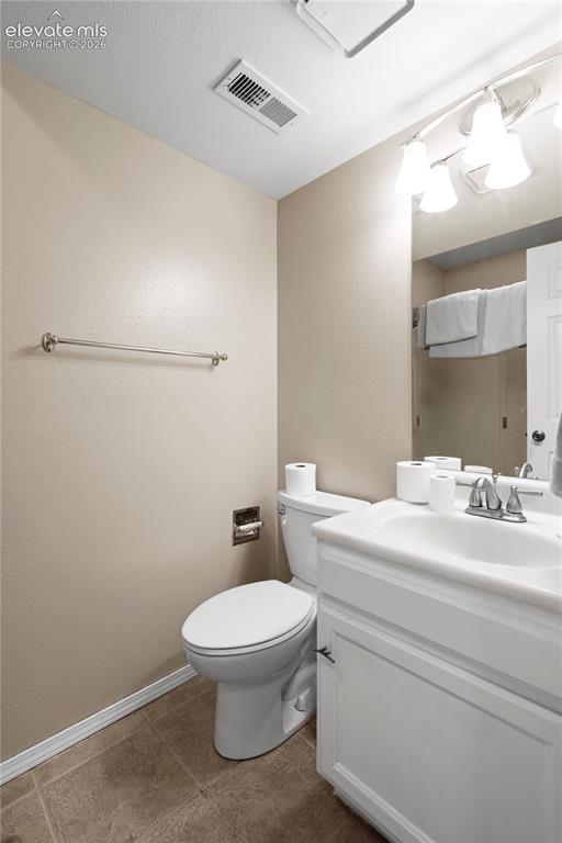 Image 34 of 43: White vanity with integrated sink, chrome faucet, and storage cabinetry