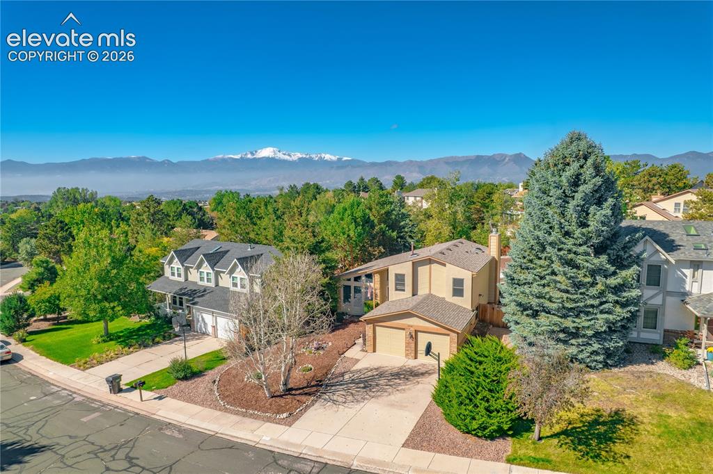 Image 38 of 43: Aerial perspective showcasing multiple properties, with a prominent two-sto