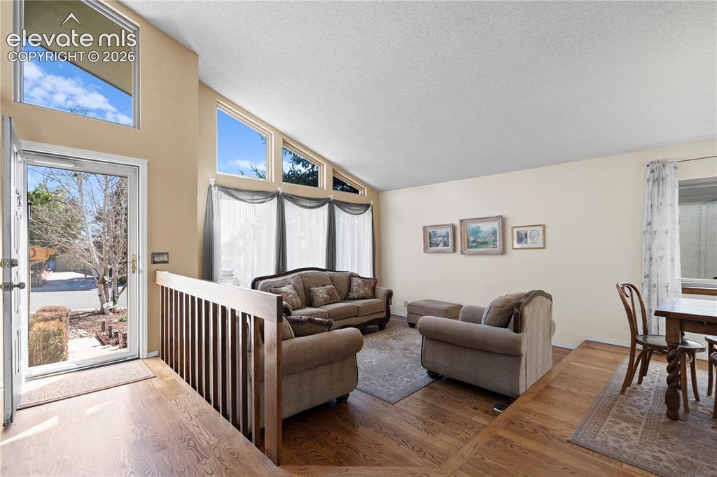 Image 4 of 43: Vaulted ceilings with clerestory windows, wood-finish flooring, and a multi