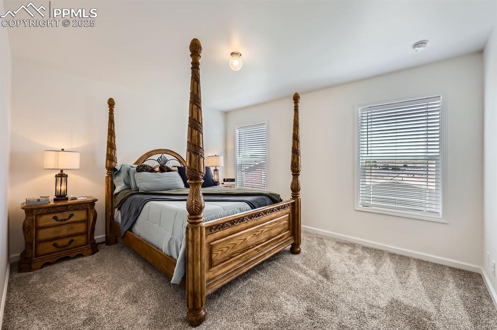 Image 14 of 28: Bedroom with carpet flooring and baseboards