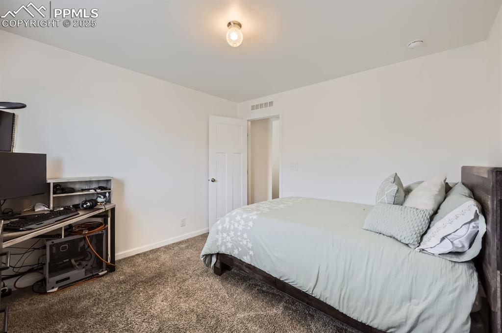 Image 20 of 28: Carpeted bedroom with baseboards