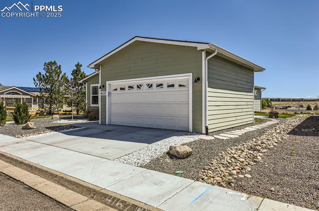 Image 3 of 28: Garage with driveway