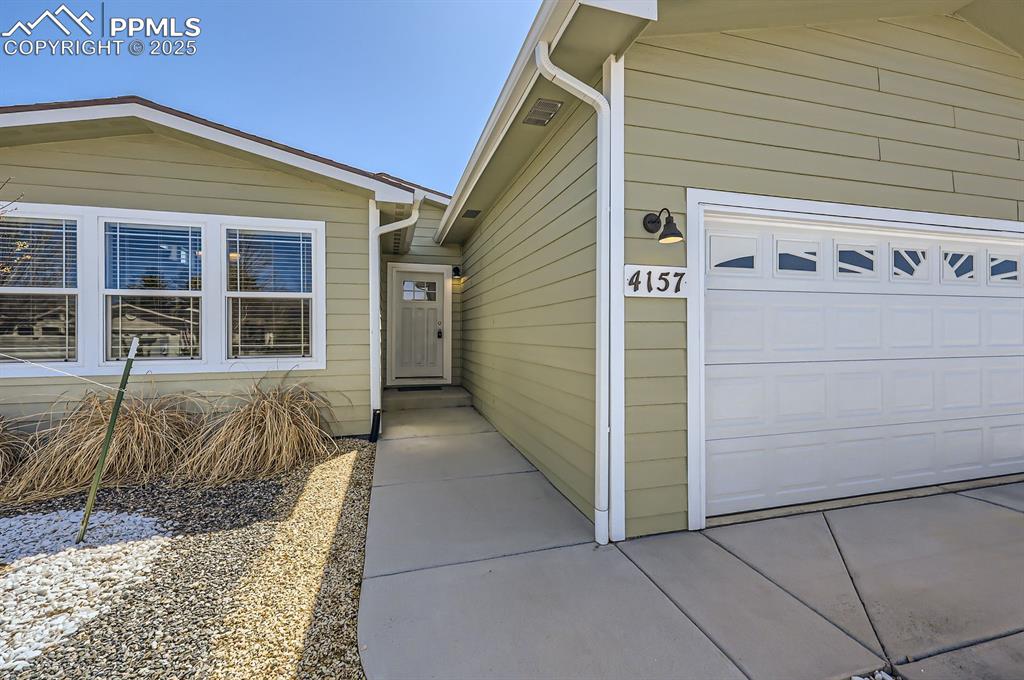 Image 4 of 28: Entrance to property with concrete driveway
