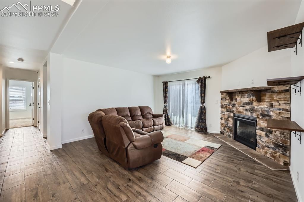 Image 5 of 28: Living room featuring wood finish floors and a fireplace