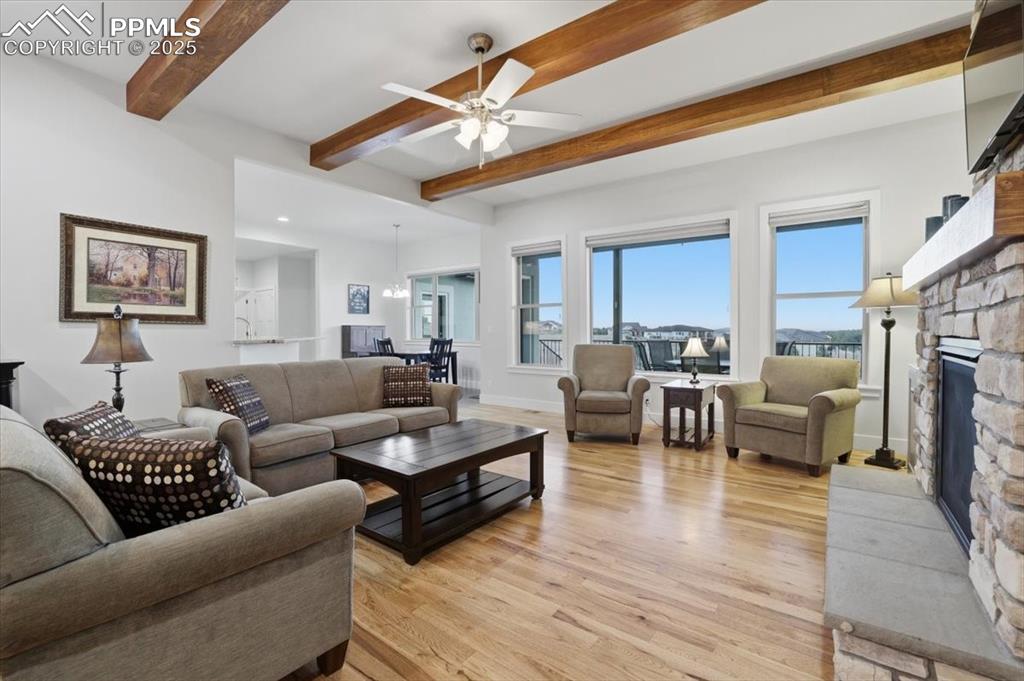 Image 10 of 49: The great room has high, beamed ceilings and is open to the kitchen.