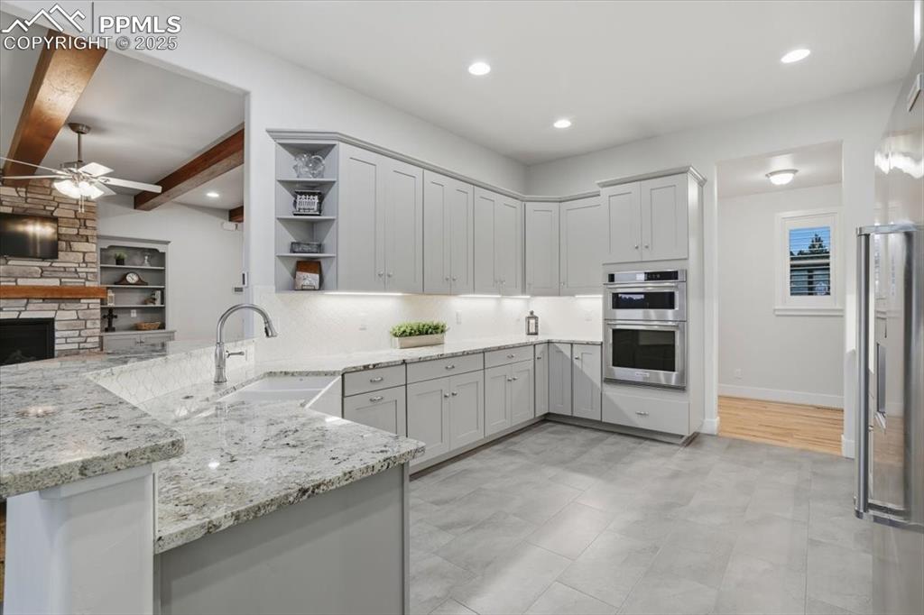 Image 14 of 49: The kitchen is spacious and stylish, with a farmhouse sink, and a great wor