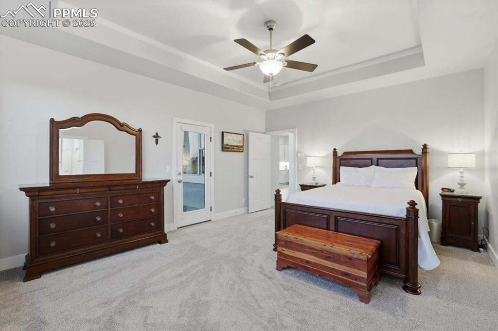 Image 21 of 49: The primary bedroom has a walk-out to the covered deck.