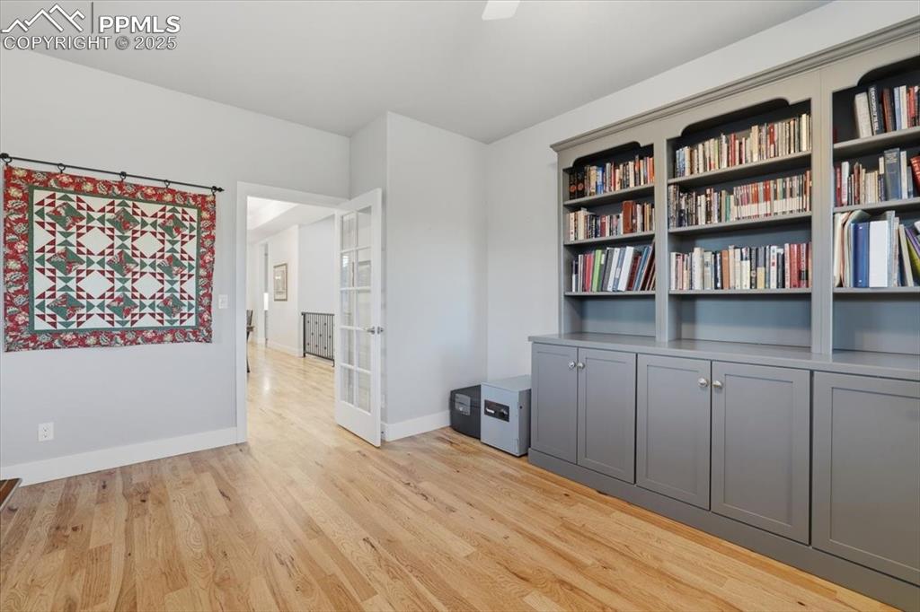 Image 28 of 49: Built-ins and picture windows make this front office a great work-from-home