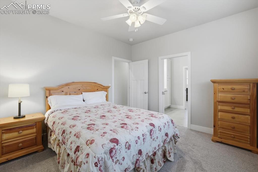 Image 31 of 49: This second of three main-floor bedrooms is spacious and has an adjacent ba