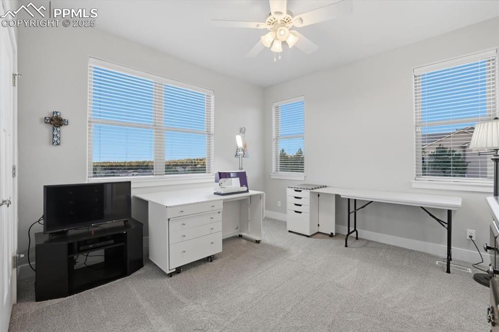 Image 34 of 49: This third main-floor bedroom has beautiful views. It is currently in use a