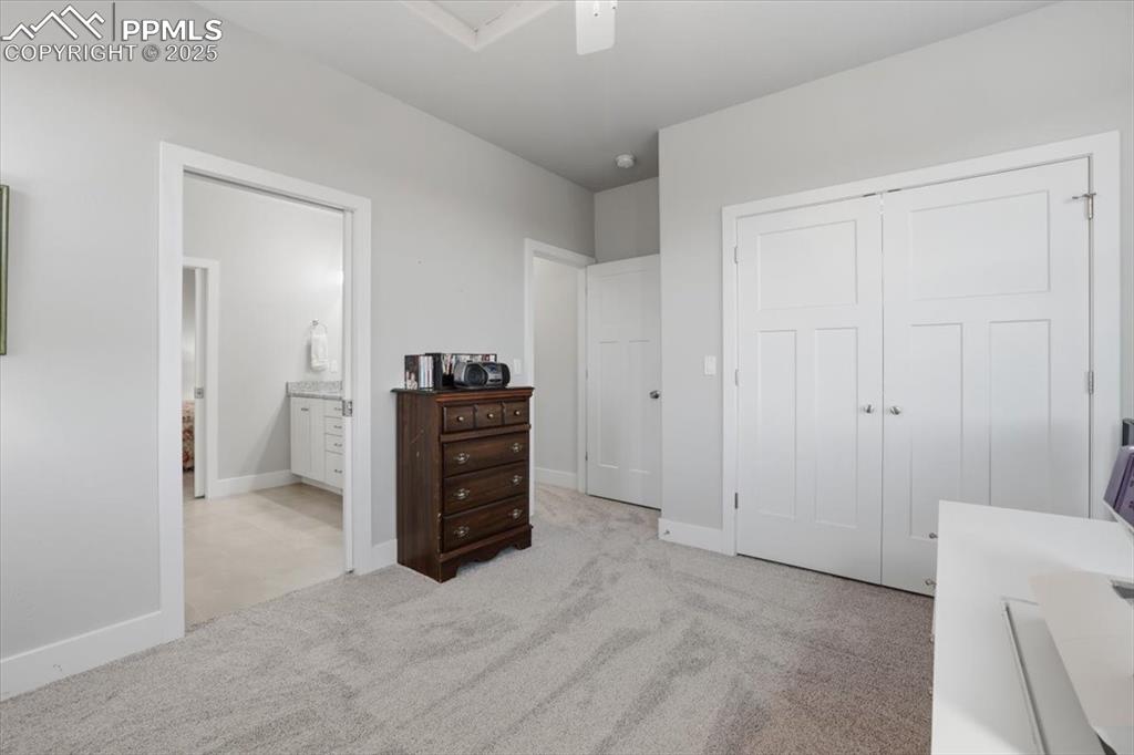 Image 35 of 49: The third main-floor bedroom has a double closet and an adjacent bathroom.