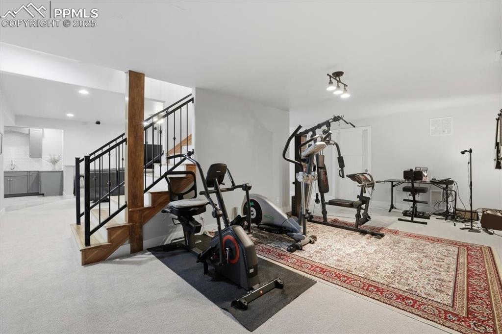 Image 38 of 49: This area off the basement family room is currently in use as a home gym.