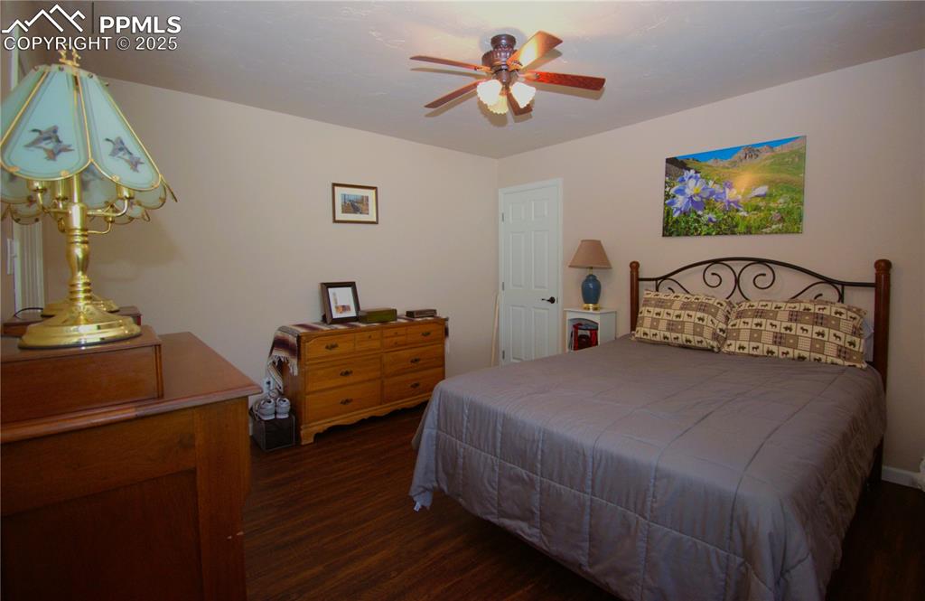 Image 16 of 23: Bedroom with luxury vinyl plank flooring and ceiling fan