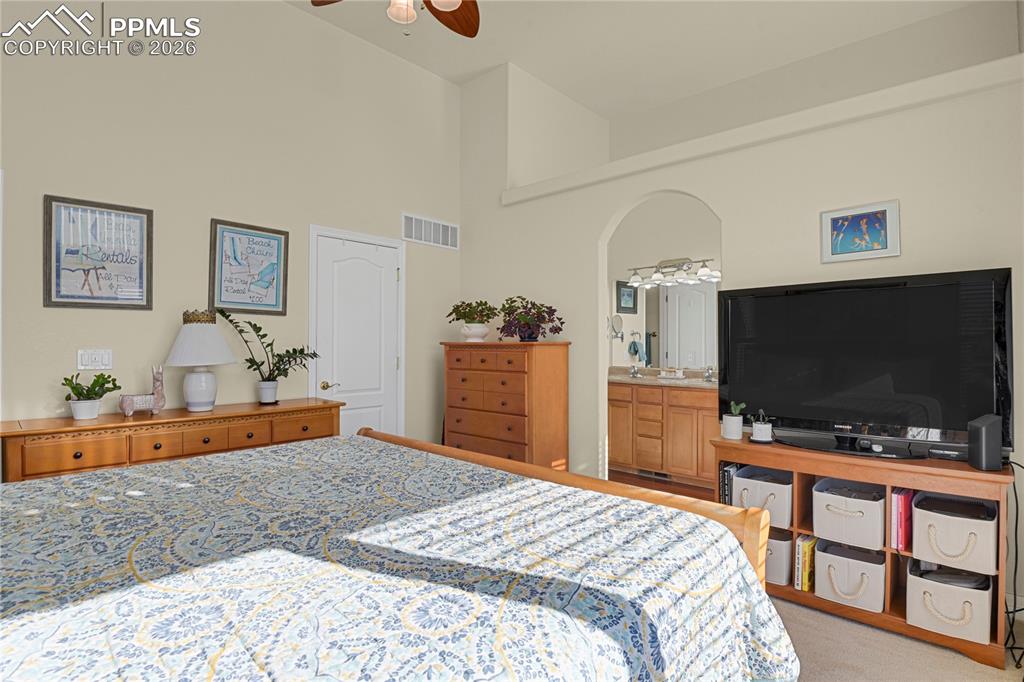 Image 12 of 41: Primary bedroom showing door to walk-in closet & entry to Primary bathroom.