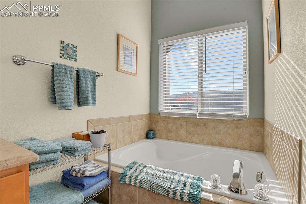 Image 14 of 41: Large soaking tub in main level Primary bathroom.