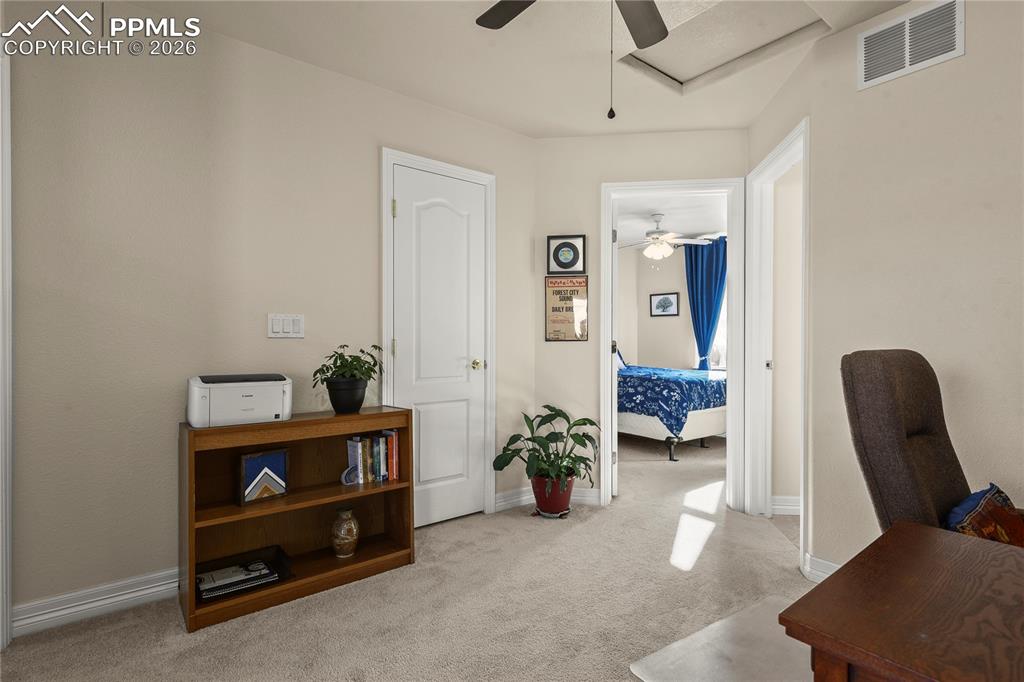 Image 29 of 41: Upper level loft/office, view of 2nd bedroom.