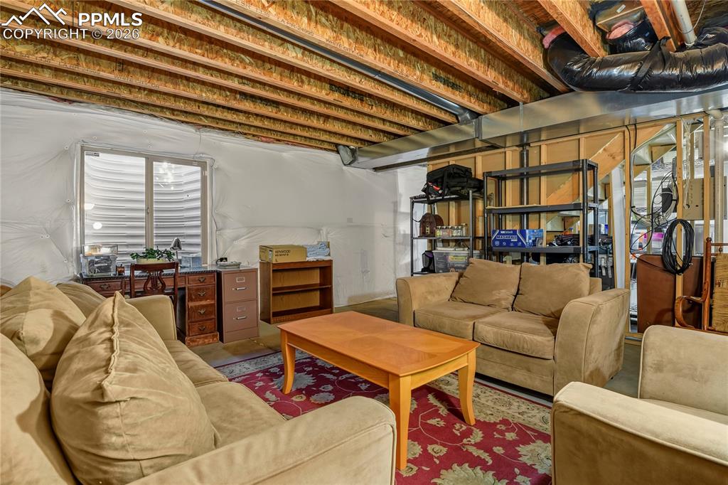 Image 36 of 41: Unfinished basement area. Stubbed in for additional bathroom.