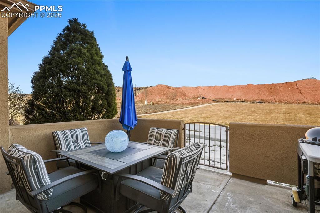 Image 6 of 41: Back patio walkout to park-like space, directly behind the home.