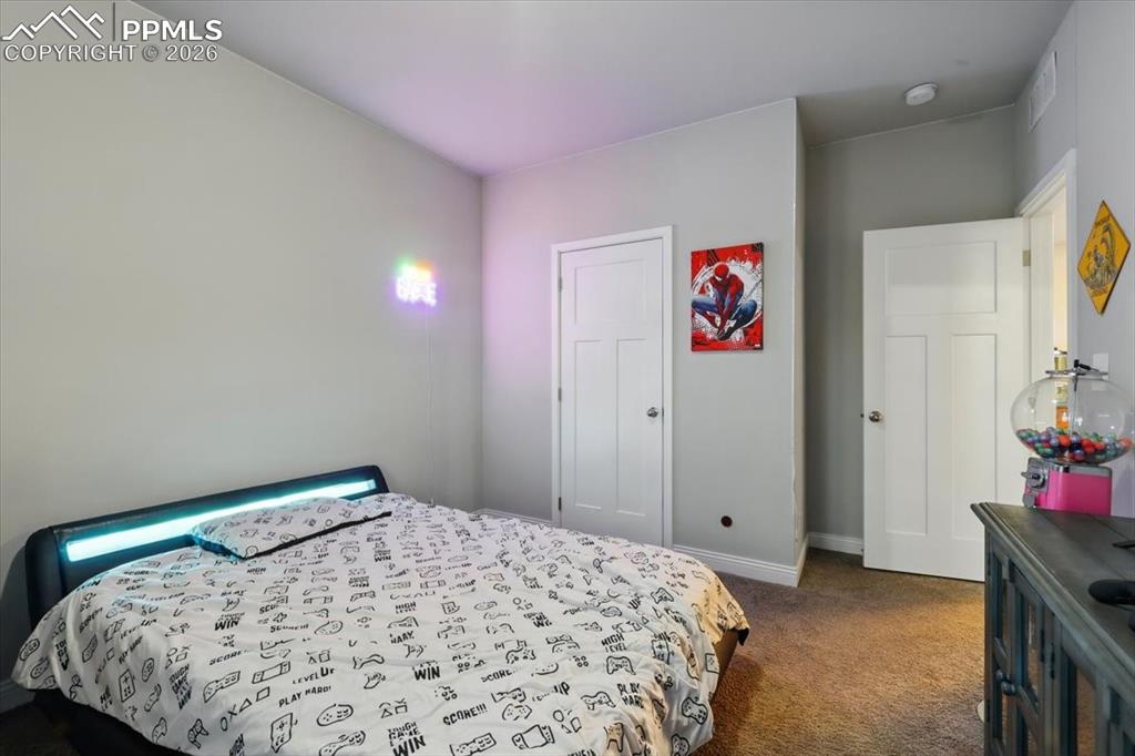 Image 21 of 30: Bedroom with carpet flooring and baseboards