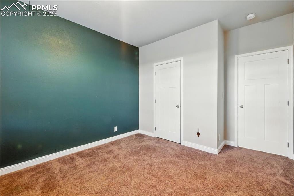 Image 23 of 30: Unfurnished bedroom with carpet and baseboards