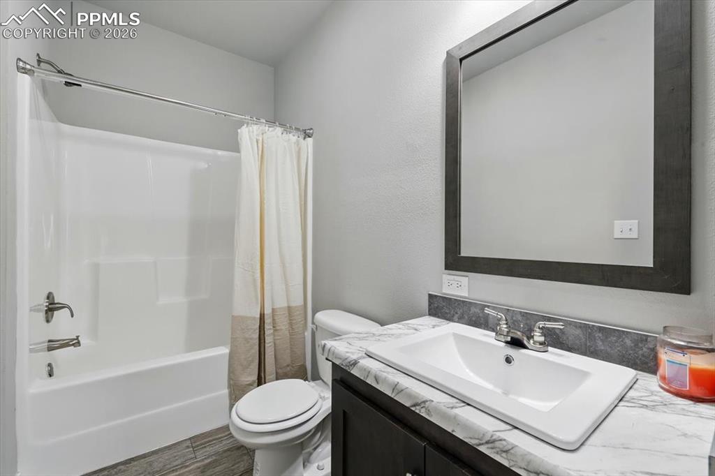 Image 26 of 30: Bathroom featuring toilet, vanity, and shower / bathtub combination with cu