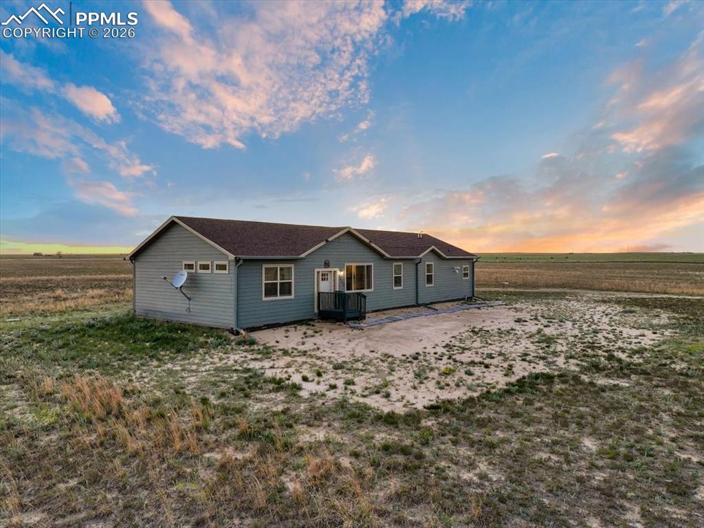 Image 3 of 30: View of back of property at dusk