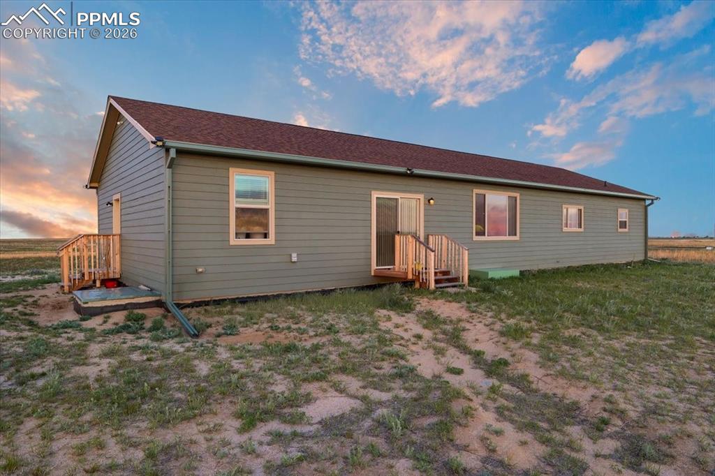 Image 30 of 30: View of back of property at dusk