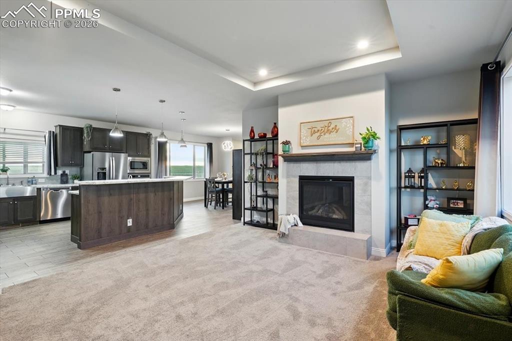 Image 6 of 30: Carpeted living area with baseboards