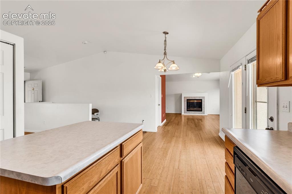 Image 10 of 32: Wood-finish flooring throughout, vaulted ceiling, and recessed lighting