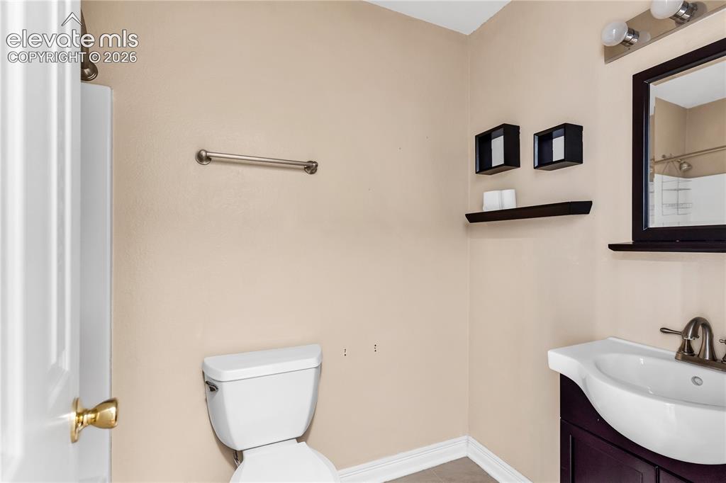 Image 12 of 32: White toilet with wall-mounted towel bar