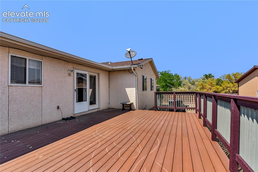 Image 28 of 32: Expansive outdoor deck with composite decking and full railing