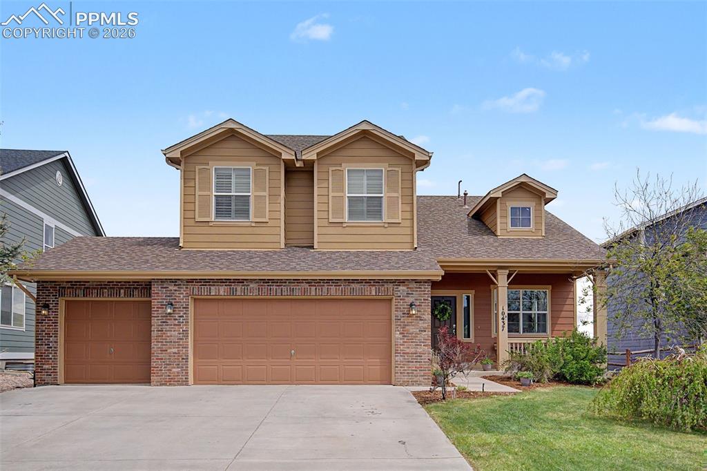 Caption: Two-story residence featuring a combination of brick and siding exterior, a two-car garage, an addit