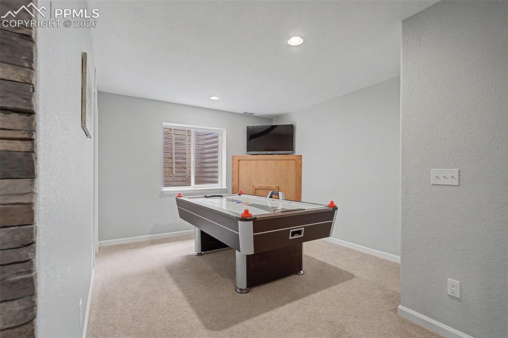Image 31 of 49: Room featuring light-toned carpeting, recessed lighting, and a window with 