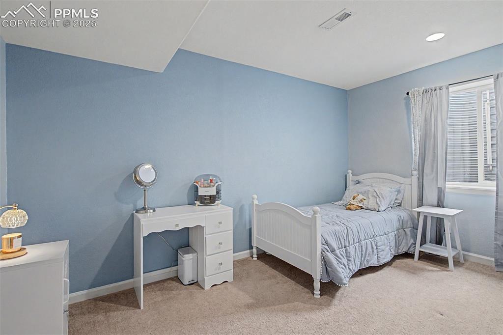 Image 35 of 49: Bedroom featuring light blue walls, recessed lighting, white trim, and a wi