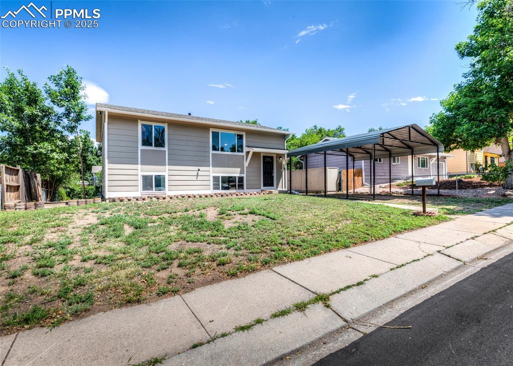 Image 45 of 48: View of front of home featuring a detached carport for 2 cars