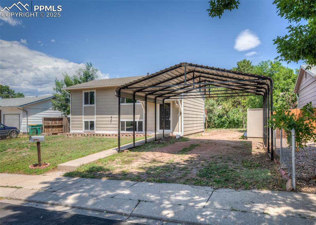 Image 48 of 48: View of front of property featuring a detached carport and exterior storage
