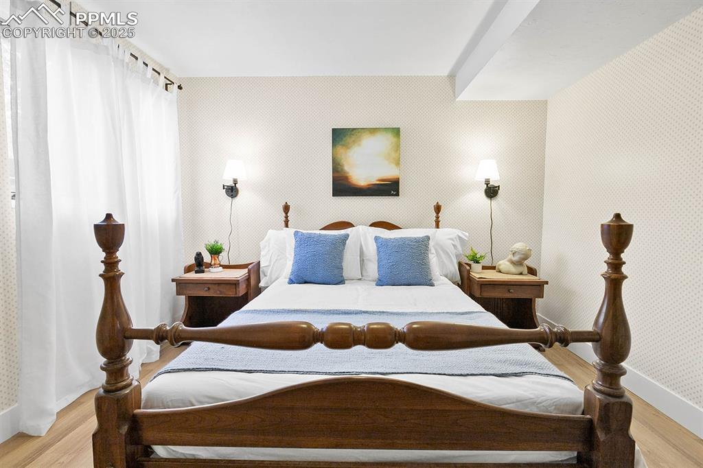 Image 17 of 45: Bedroom with wood finished floors and baseboards