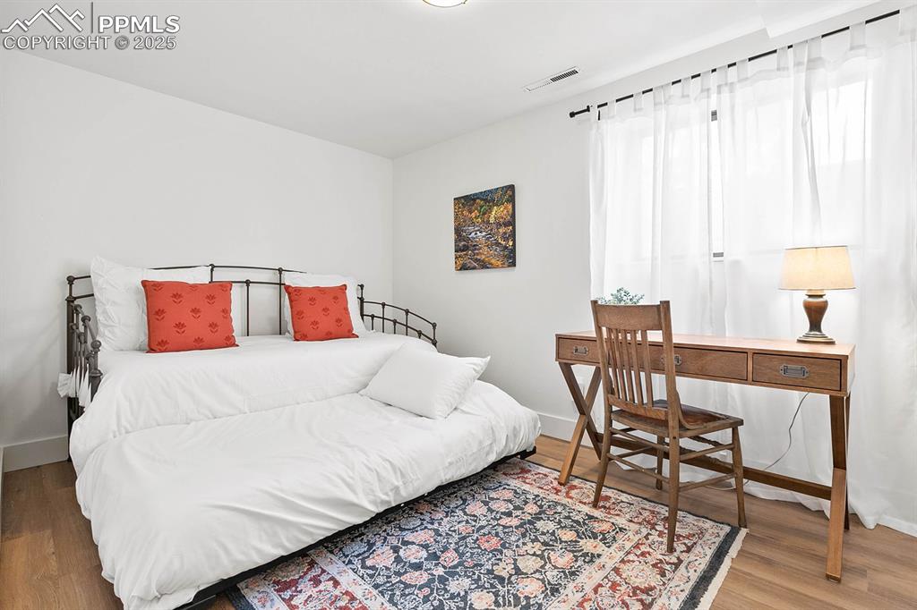 Image 18 of 45: Bedroom with baseboards and wood finished floors