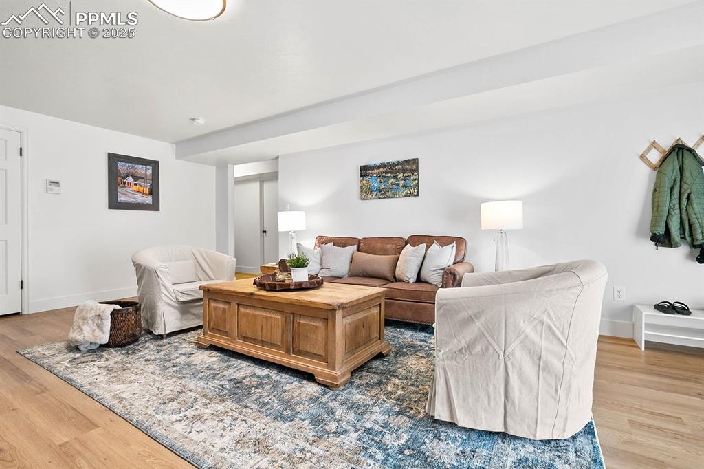 Image 22 of 45: Living room featuring wood finished floors and baseboards