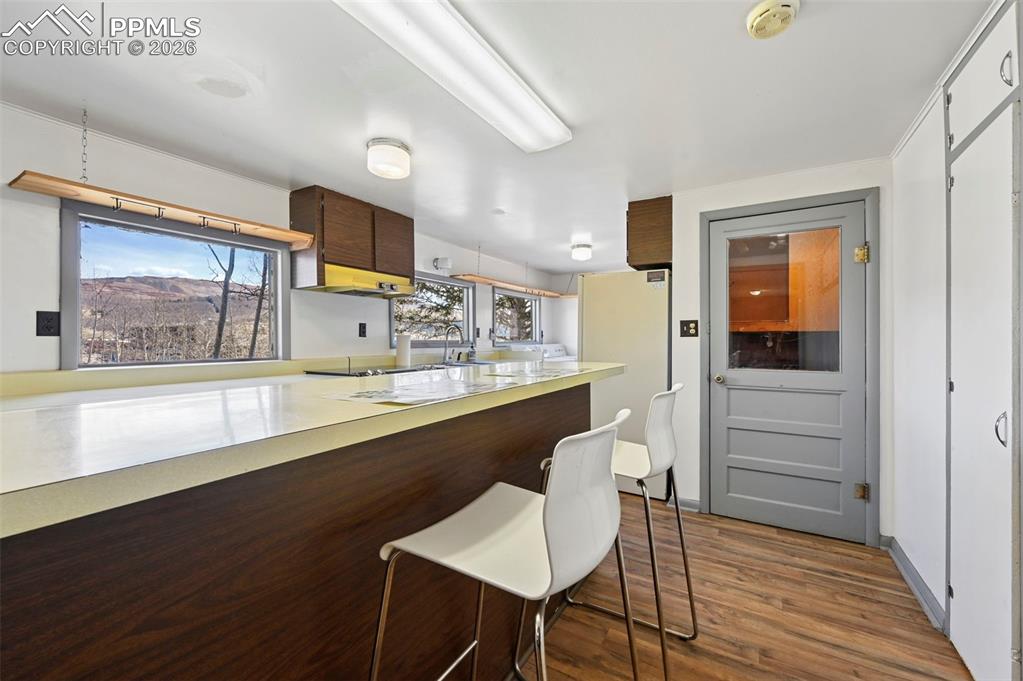 Image 11 of 35: Kitchen with laundry and door to sunroom/bonus room