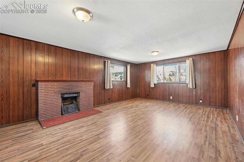 Image 4 of 35: main living room with cast iron log fireplace