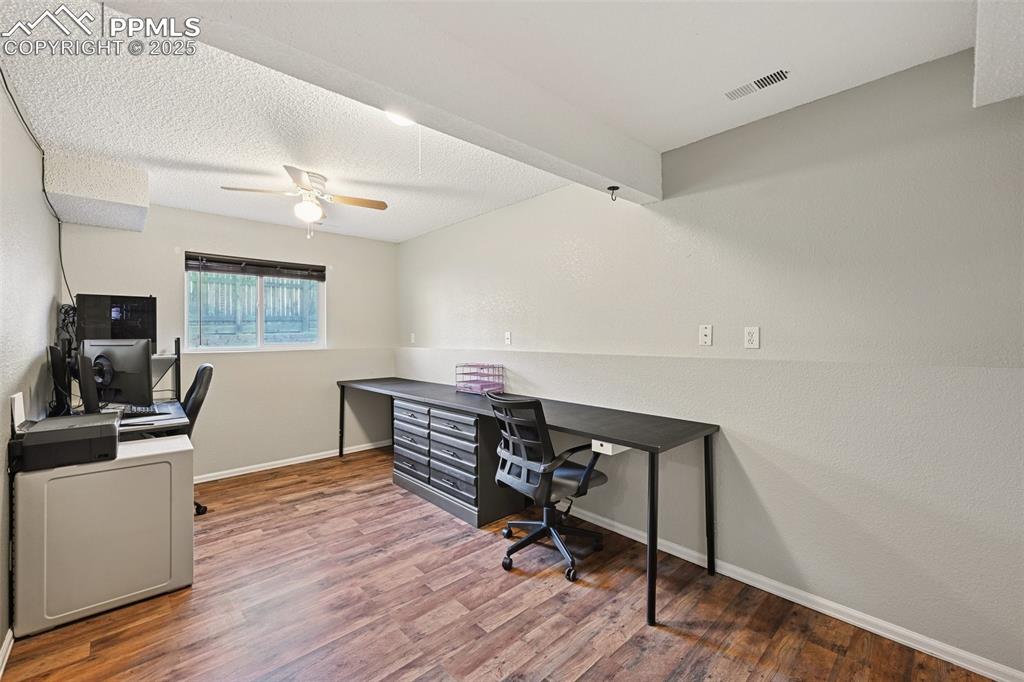 Image 19 of 23: Office featuring light wood-style flooring, a textured ceiling, a textured