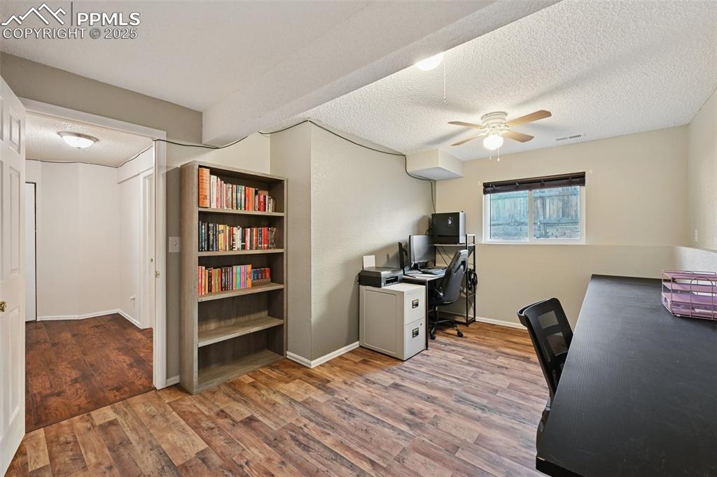 Image 20 of 23: Office featuring a textured ceiling, light wood-style flooring, and a ceili