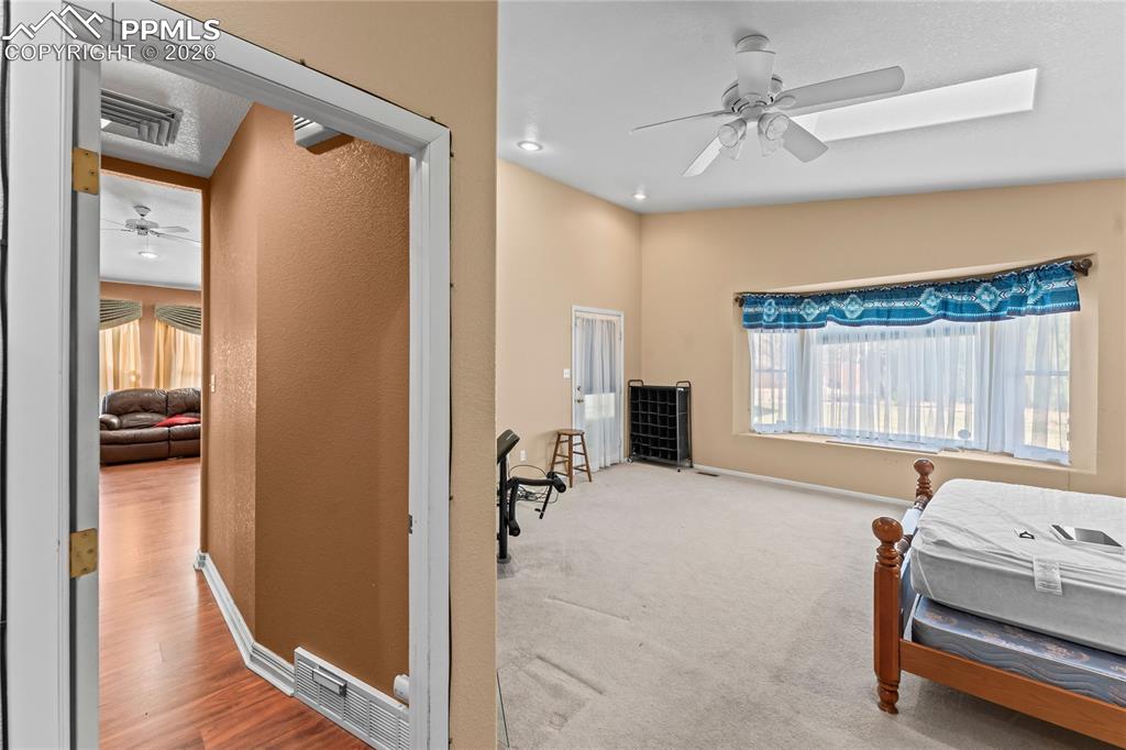Image 16 of 41: Bedroom featuring ceiling fan and light carpet