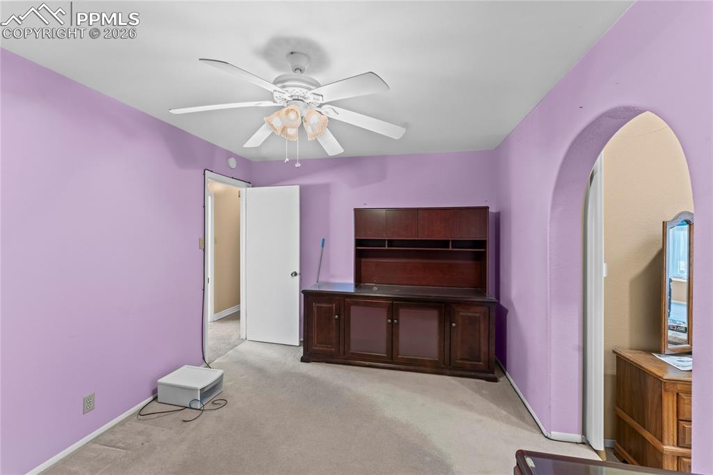 Image 20 of 41: Unfurnished bedroom featuring light colored carpet, arched walkways, and ce